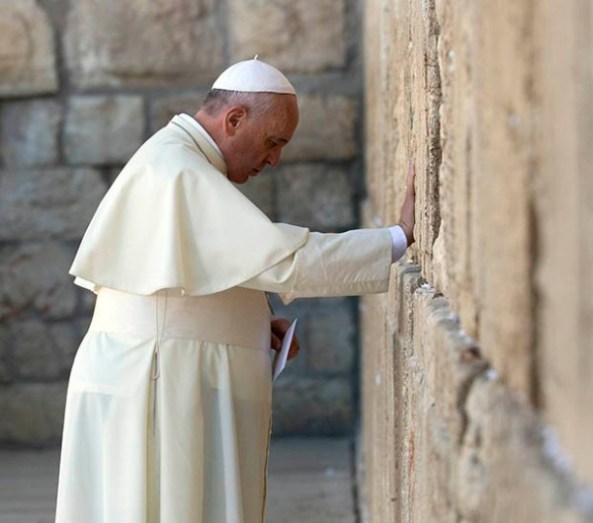 Pope Francis touches the stones of the Western Wall, Judaism's holiest prayer site, in Jerusalem's Old City