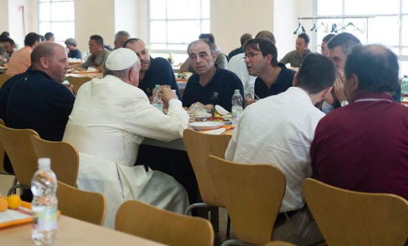 Pope Francis talks with Vatican workers as he arrives for a surprise visit at the Vatican canteen